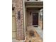 Inviting front entryway featuring a brick facade and well-lit porch at 1366 Image Xing, Lawrenceville, GA 30045