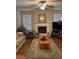 Inviting living room with a ceiling fan, fireplace, plush sofas, and ample natural light from large windows at 1366 Image Xing, Lawrenceville, GA 30045