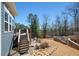 Backyard featuring a wooden deck with stairs and a patio with seating and a rock retaining wall at 139 Stargaze Rdg, Canton, GA 30114