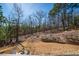 Inviting backyard space with stone retaining wall and tree views, creating a serene outdoor retreat at 139 Stargaze Rdg, Canton, GA 30114