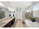 Open-concept bathroom featuring a double vanity, stand-up shower, and soaking tub at 139 Stargaze Rdg, Canton, GA 30114