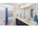 Well-lit bathroom featuring a double vanity and a shower with a blue shower curtain at 139 Stargaze Rdg, Canton, GA 30114