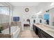 Bright bathroom with double vanity, bathtub, tiled floors, and a view into the bedroom at 139 Stargaze Rdg, Canton, GA 30114