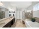 Bright bathroom features a double sink vanity, soaking tub, and separate glass enclosed shower at 139 Stargaze Rdg, Canton, GA 30114