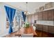 Bright dining area featuring hardwood floors, built-in cabinetry, and a large window with stylish curtains at 139 Stargaze Rdg, Canton, GA 30114