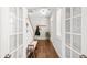 Inviting entryway with hardwood floors, a charming bench, coat rack, and elegant French doors offering a warm welcome at 139 Stargaze Rdg, Canton, GA 30114