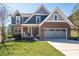Charming two-story home with a brick facade, manicured lawn, and a welcoming front porch at 139 Stargaze Rdg, Canton, GA 30114