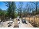 The backyard features a stamped concrete patio with an inviting fire pit area surrounded by mature trees at 139 Stargaze Rdg, Canton, GA 30114