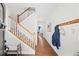 A bright foyer featuring a staircase, hardwood floors, and a coat rack, leading into a cozy living space at 139 Stargaze Rdg, Canton, GA 30114