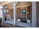 Close-up of the inviting front porch with gray door and decorative potted plants at 139 Stargaze Rdg, Canton, GA 30114