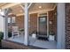 Inviting front porch with brick accents, rocking chair, and decorative plants at 139 Stargaze Rdg, Canton, GA 30114