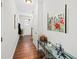 Hallway featuring beautiful hardwood floors, an elegant glass console table, and modern art, creating a stylish transition at 139 Stargaze Rdg, Canton, GA 30114