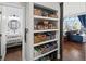 Open pantry shelving for ample storage of food and kitchen items, with a bathroom in the background at 139 Stargaze Rdg, Canton, GA 30114