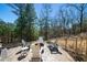 Outdoor patio area with fire pit, seating and surrounding trees at 139 Stargaze Rdg, Canton, GA 30114