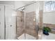 Walk-in shower features a glass door, tiled walls, and a convenient bench at 139 Stargaze Rdg, Canton, GA 30114