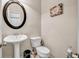 Cozy half-bathroom with a pedestal sink and toilet at 4439 Persian Ct, Snellville, GA 30039