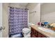 Bathroom featuring patterned shower curtain, vanity with granite counter, and ample storage at 4439 Persian Ct, Snellville, GA 30039