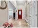 Welcoming entryway with a red front door, wood floors, and view into living area at 4439 Persian Ct, Snellville, GA 30039