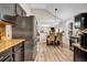 Spacious kitchen with stainless steel refrigerator, dark cabinetry, and a view to the dining area at 4439 Persian Ct, Snellville, GA 30039