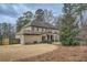 Expansive backyard featuring a spacious lawn, mature trees, and a lovely covered patio area, perfect for outdoor enjoyment at 2998 Octavia Cir, Marietta, GA 30062