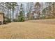 Large grass backyard with a fence, mature trees, and a glimpse of the pool area at 2998 Octavia Cir, Marietta, GA 30062