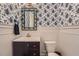 Stylish powder room featuring a unique blue wallpaper, decorative mirror, and wood vanity at 2998 Octavia Cir, Marietta, GA 30062
