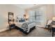 Cozy bedroom featuring a comfortable bed with decorative pillows, a side table, and a window at 2998 Octavia Cir, Marietta, GA 30062