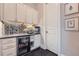 Charming butler's pantry featuring custom cabinets, beverage fridge, and granite countertop at 2998 Octavia Cir, Marietta, GA 30062