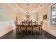 Formal dining room featuring a decorative chandelier, large windows, and wainscoting at 2998 Octavia Cir, Marietta, GA 30062
