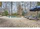 A backyard kidney shaped pool is surrounded by lounge chairs, brick pavers, and decorative umbrellas at 2998 Octavia Cir, Marietta, GA 30062