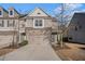 Charming townhome with stone facade and attached two-car garage, perfect for modern living at 3238 Spicy Cedar Ln, Lithonia, GA 30038