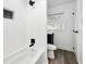 Clean, bright bathroom with white tiled walls and shower, and modern fixtures at 3687 Venus Nw Pl, Atlanta, GA 30331