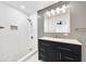 Modern bathroom features walk-in shower, gray walls, and updated vanity with lighting at 3687 Venus Nw Pl, Atlanta, GA 30331