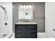 Updated bathroom with walk in shower and gray vanity with updated lighting at 3687 Venus Nw Pl, Atlanta, GA 30331