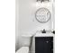 A minimalist bathroom features a black vanity, round mirror, and modern lighting fixtures at 3687 Venus Nw Pl, Atlanta, GA 30331