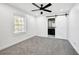 Bedroom with gray carpet, ceiling fan, bathroom access via sliding barn door at 3687 Venus Nw Pl, Atlanta, GA 30331
