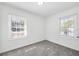 A bright and airy bedroom featuring two windows with natural light and neutral carpet at 3687 Venus Nw Pl, Atlanta, GA 30331