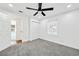 Bright bedroom with neutral carpet, ceiling fan, closet, and natural light at 3687 Venus Nw Pl, Atlanta, GA 30331