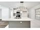 Modern kitchen island featuring a stainless steel faucet and overhead lighting at 3687 Venus Nw Pl, Atlanta, GA 30331