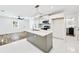 Bright kitchen with island, stainless appliances, white cabinets, and modern lighting at 3687 Venus Nw Pl, Atlanta, GA 30331