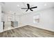 Bright open-concept kitchen with an island, stainless appliances, and modern lighting at 3687 Venus Nw Pl, Atlanta, GA 30331
