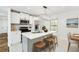 Modern kitchen featuring white cabinets, stainless steel appliances, and an island with seating at 3687 Venus Nw Pl, Atlanta, GA 30331