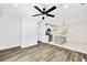 Open-concept living room flows into kitchen with stainless steel appliances and island at 3687 Venus Nw Pl, Atlanta, GA 30331