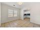 Bright dining room with beige tile and lots of light from the large window at 3723 Glenwood Rd, Decatur, GA 30032