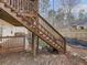 Wooden stairs lead to an elevated deck and backyard, creating an inviting outdoor space at 5228 Boone Ct, Villa Rica, GA 30180