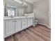 Bathroom featuring dual sink vanity with modern fixtures and wood flooring at 5228 Boone Ct, Villa Rica, GA 30180