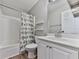 Bright bathroom with tub, shower, white vanity and colorful bird-themed curtain at 5228 Boone Ct, Villa Rica, GA 30180