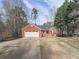 Charming brick home featuring an attached two-car garage and well-maintained front yard at 5228 Boone Ct, Villa Rica, GA 30180