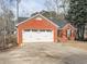 Well-kept brick home with a two-car garage, complemented by a tidy front lawn at 5228 Boone Ct, Villa Rica, GA 30180
