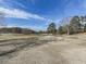 Picturesque golf course featuring a sand trap, lush green fairways, and mature trees under a clear blue sky at 5228 Boone Ct, Villa Rica, GA 30180